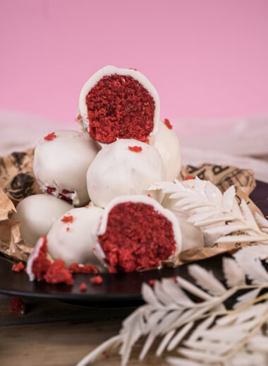 Cross-section of strawberry cake pop showing red interior and white coating