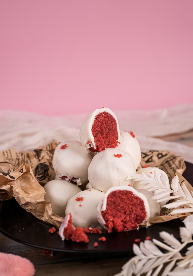 Cut strawberry cake pops revealing vibrant red cake interior