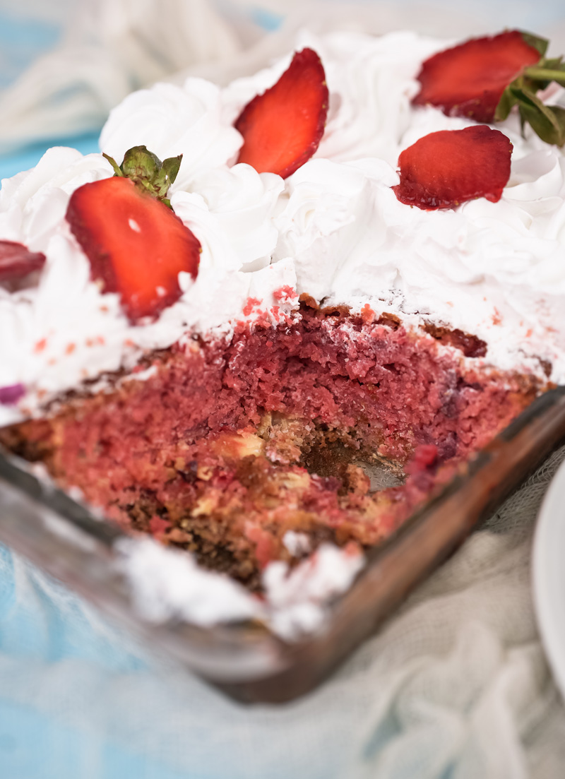 Strawberry earthquake cake with sections cut showing interior layers
