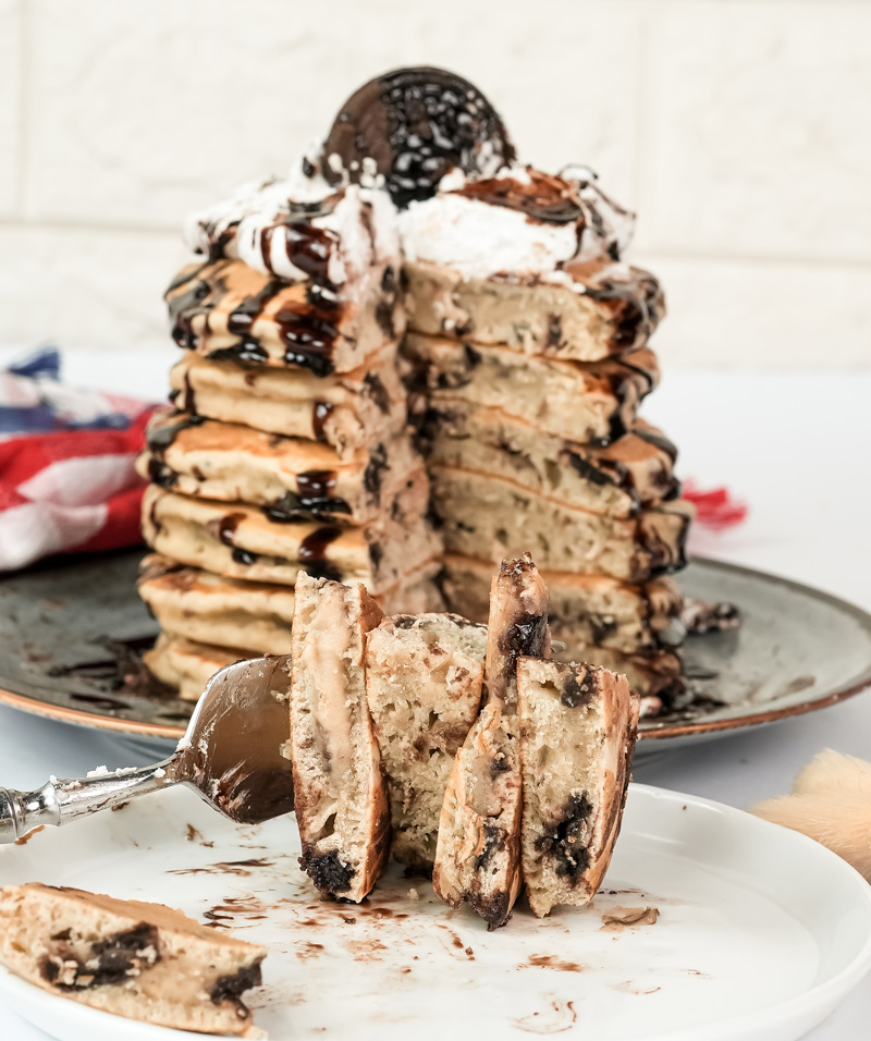 Cut Oreo pancakes displaying fluffy texture with chocolate cookie bits