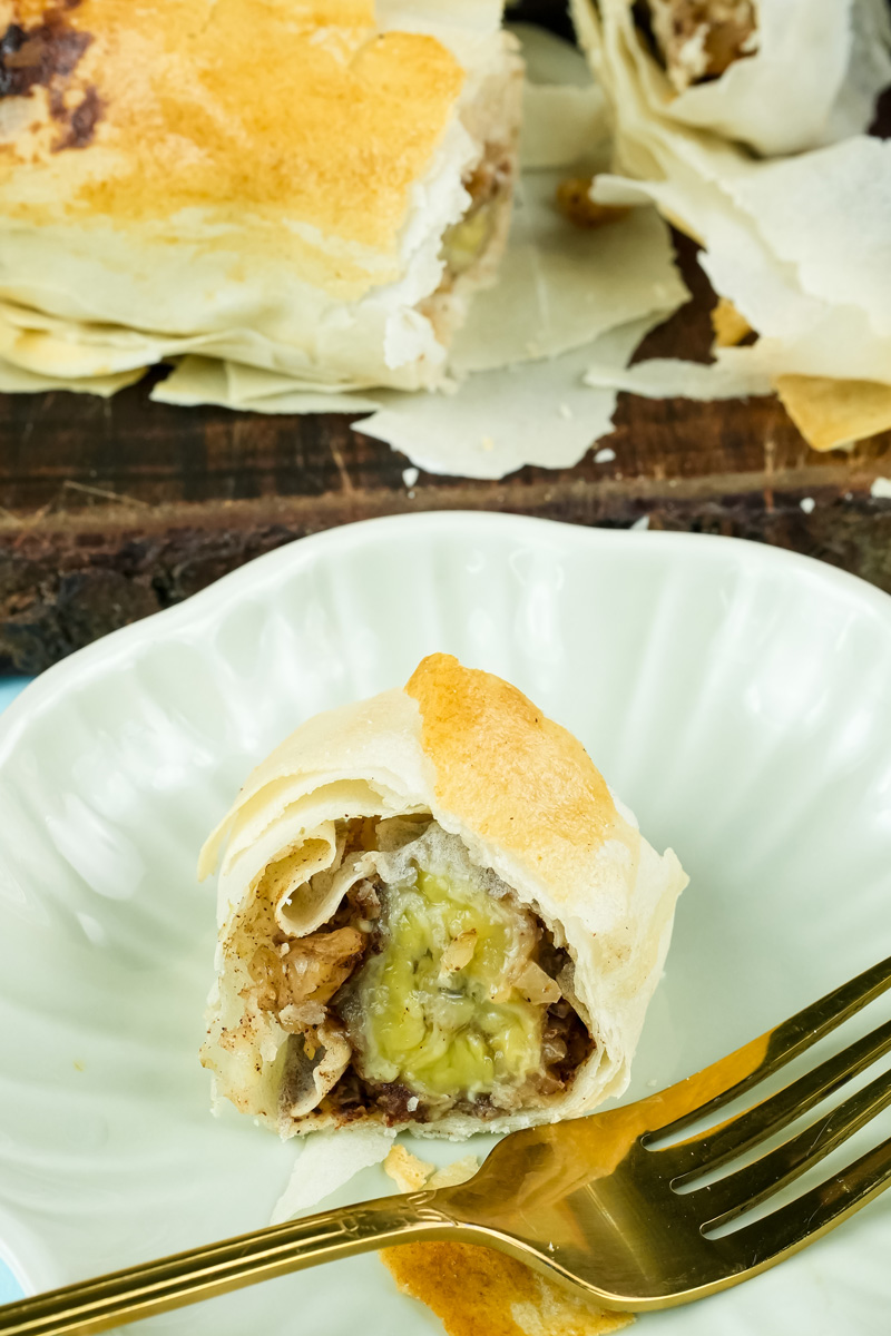 Banana strudel dessert served on white plate