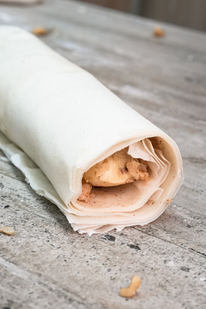 Banana strudel rolled in parchment before baking