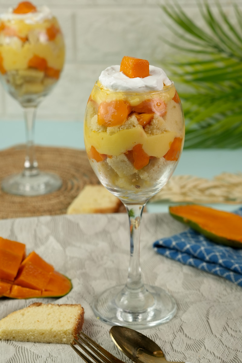 Completed mango trifle with custard, fruit and whipped cream layers