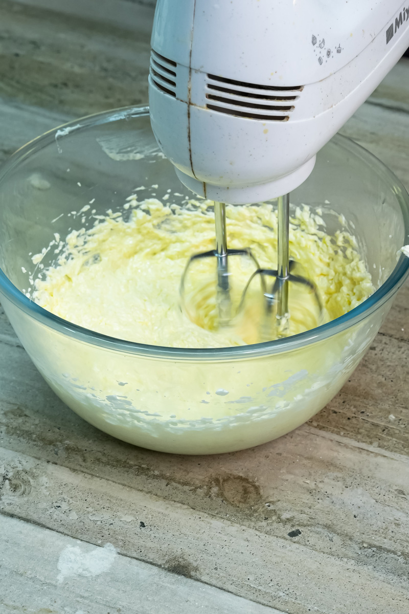 Creaming butter and sugar together with a hand mixer for banana bread batter.