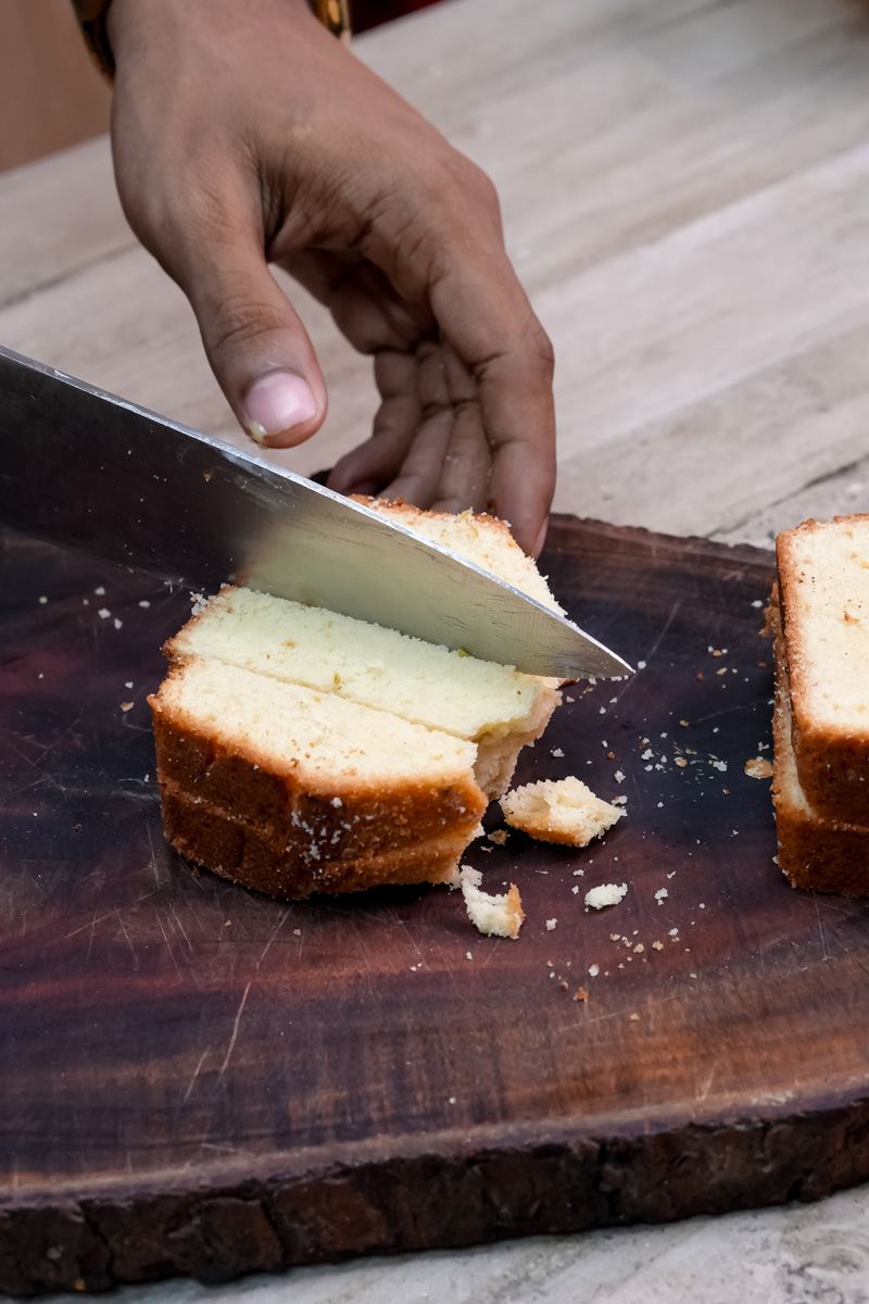 Cutting pound cake into cubes for mango trifle layers