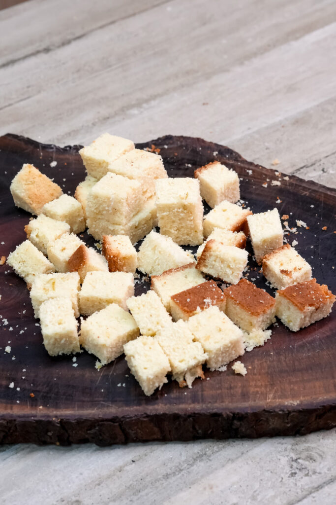 Diced cake pieces arranged on cutting board for trifle