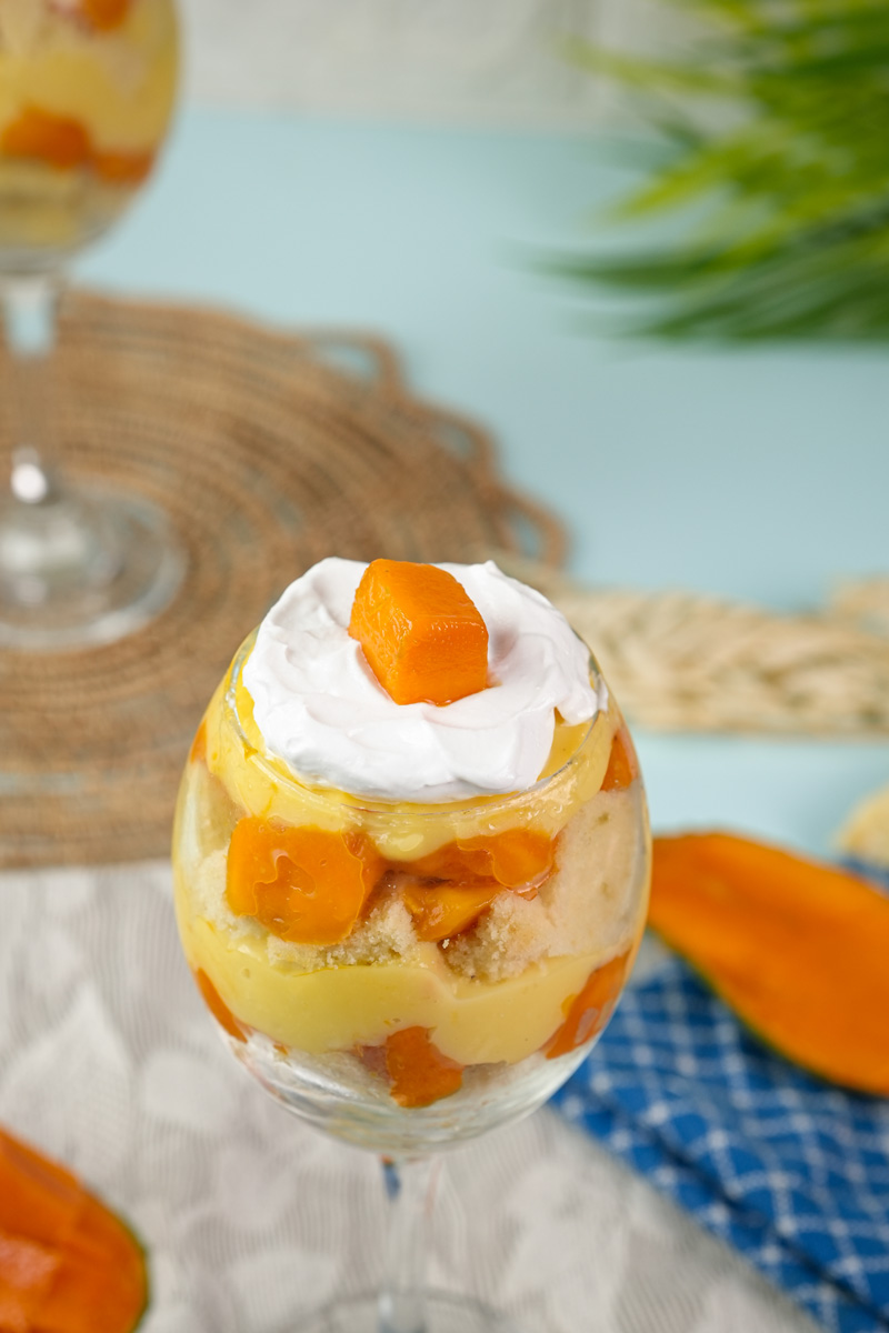 Elegant mango trifle presentation with cream topping