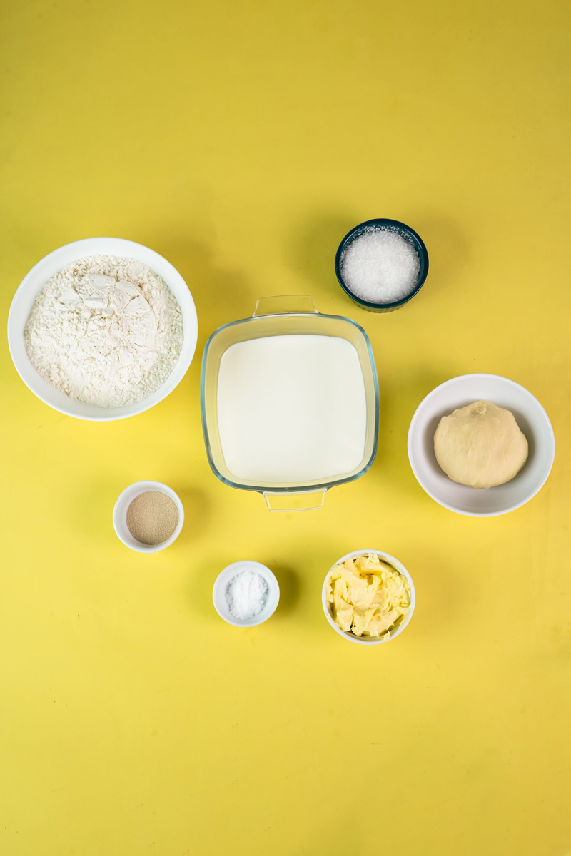 Japanese milk bread ingredients - flour, milk, yeast, butter laid out