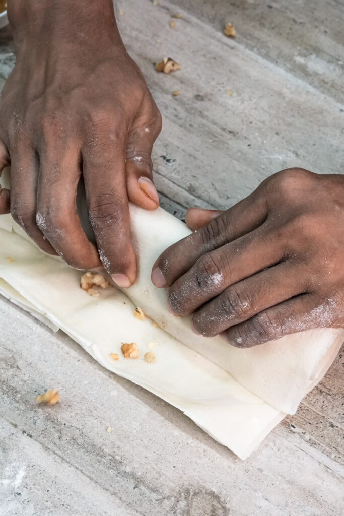Rolling banana strudel in parchment paper technique