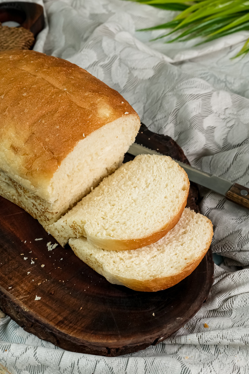 Sliced English Muffin Bread on a board, showing its soft, open crumb texture.