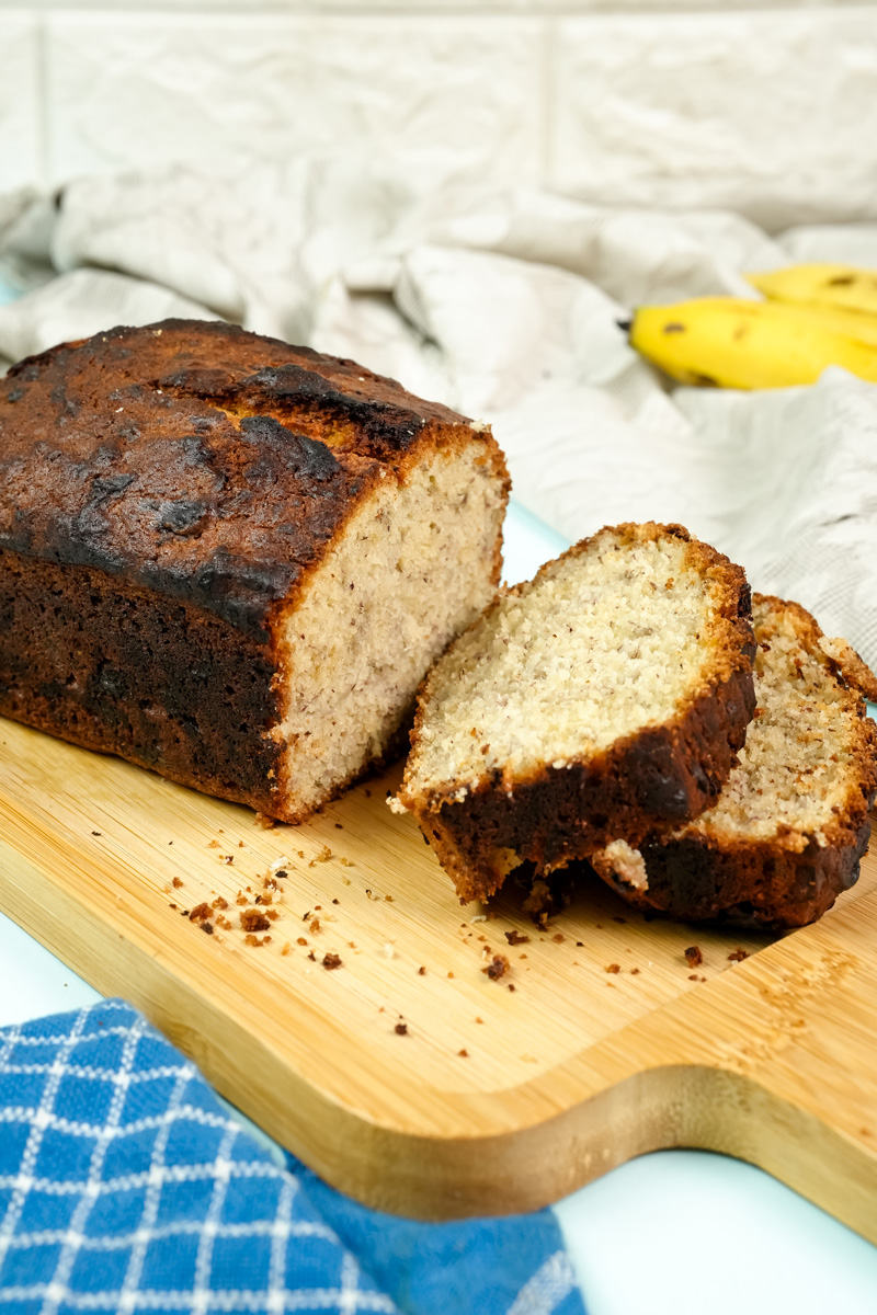 Sliced Hawaiian banana bread on a cutting board, showing the moist texture.