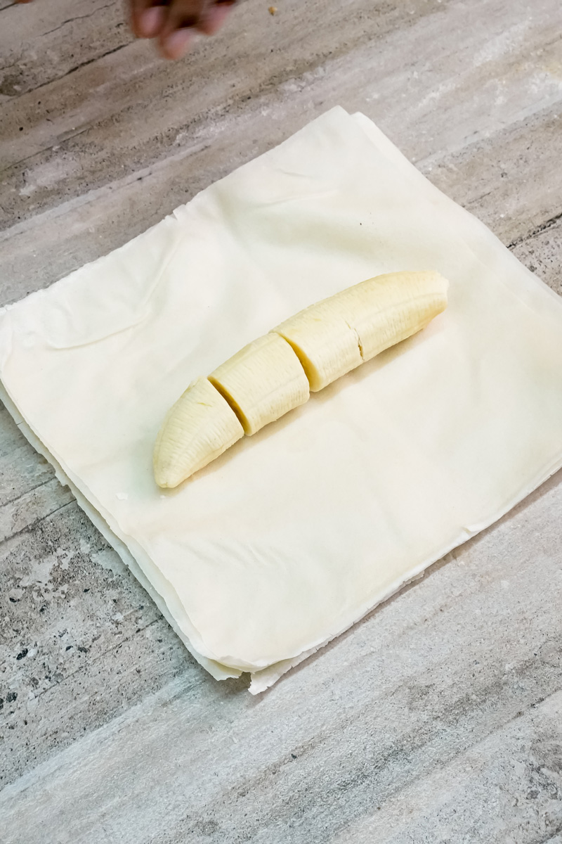 Sliced banana pieces arranged on parchment for strudel filling