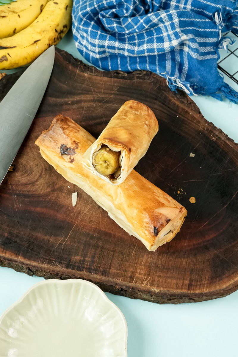 Sliced banana strudel showing walnut filling inside