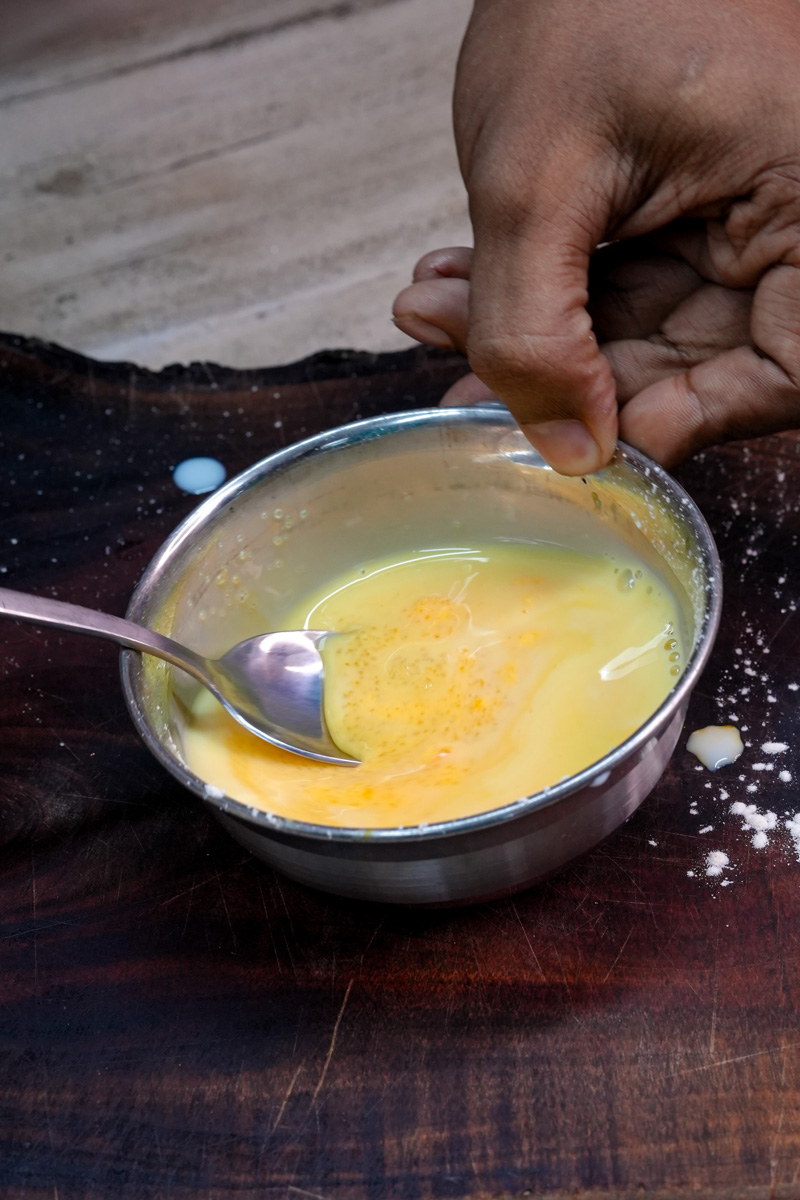 Whisking custard mixture by hand for mango trifle