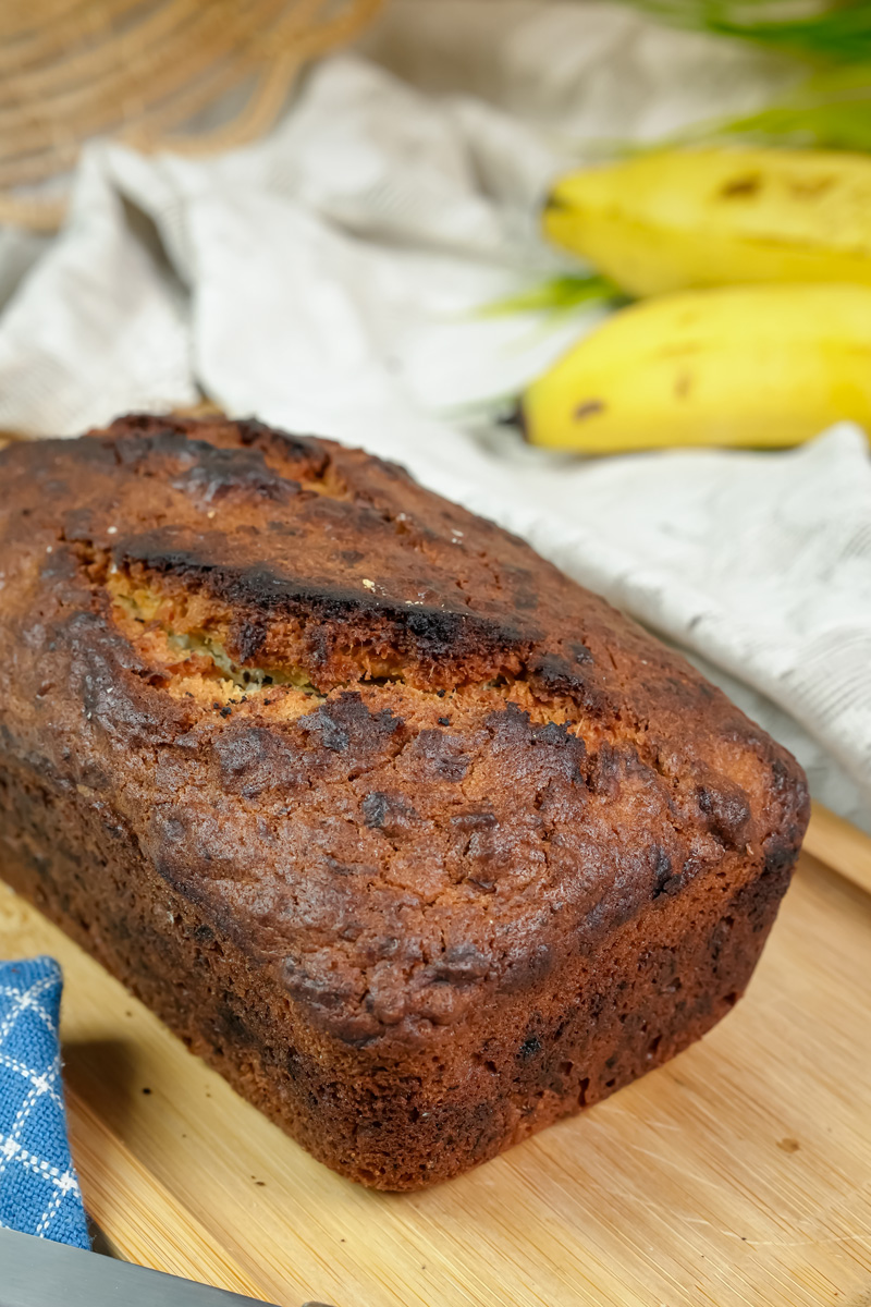 A close-up of the dark, caramelized crust of the Hawaiian banana bread loaf.
