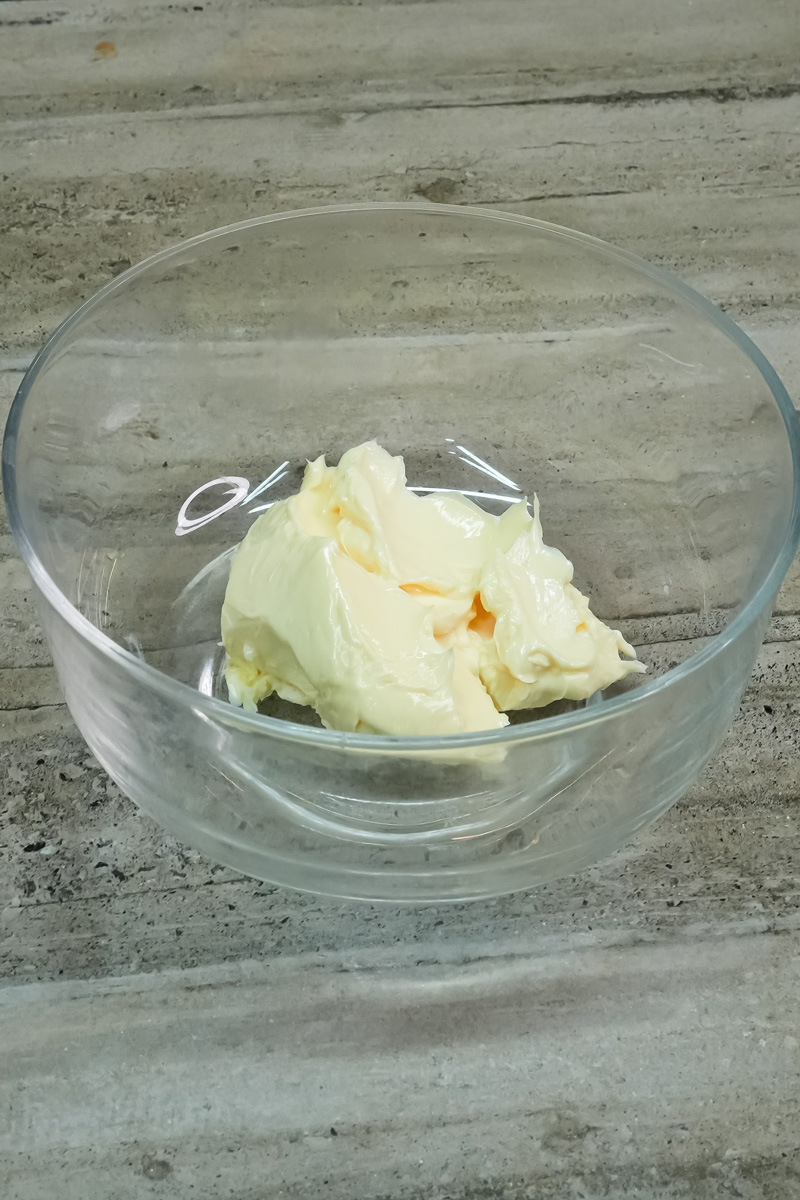 A bowl of softened butter for a cookie recipe