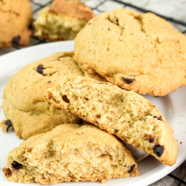 A broken cookie on a plate, showing its soft, crumbly texture