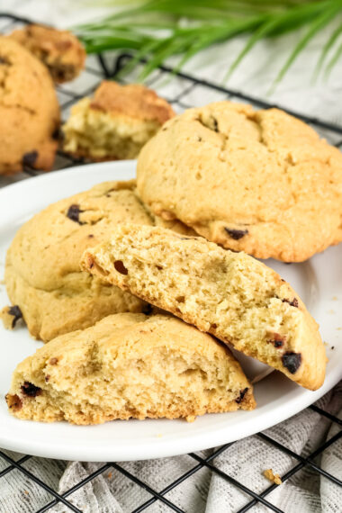 A broken cookie on a plate, showing its soft, crumbly texture