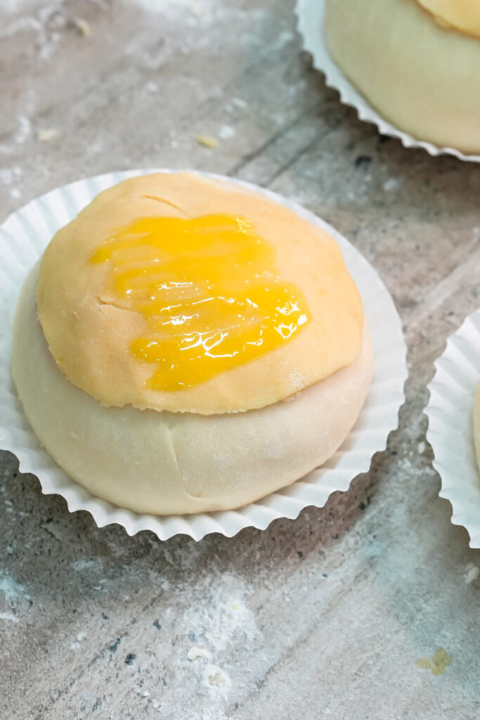 Adding custard filling to pineapple bun center