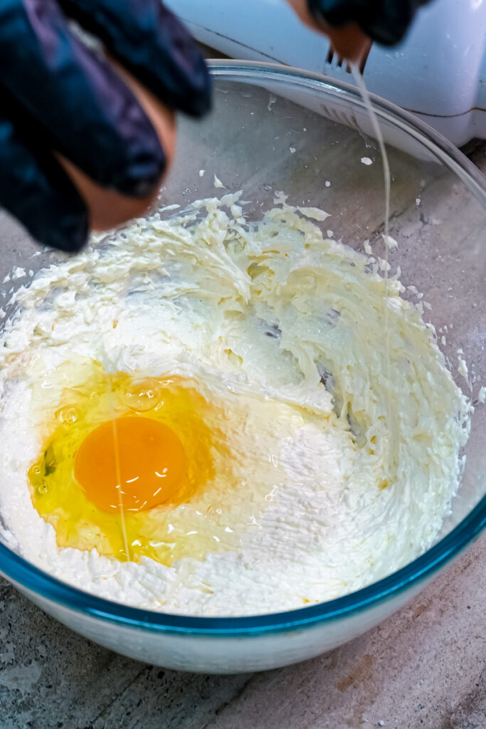Adding egg to creamed butter mixture