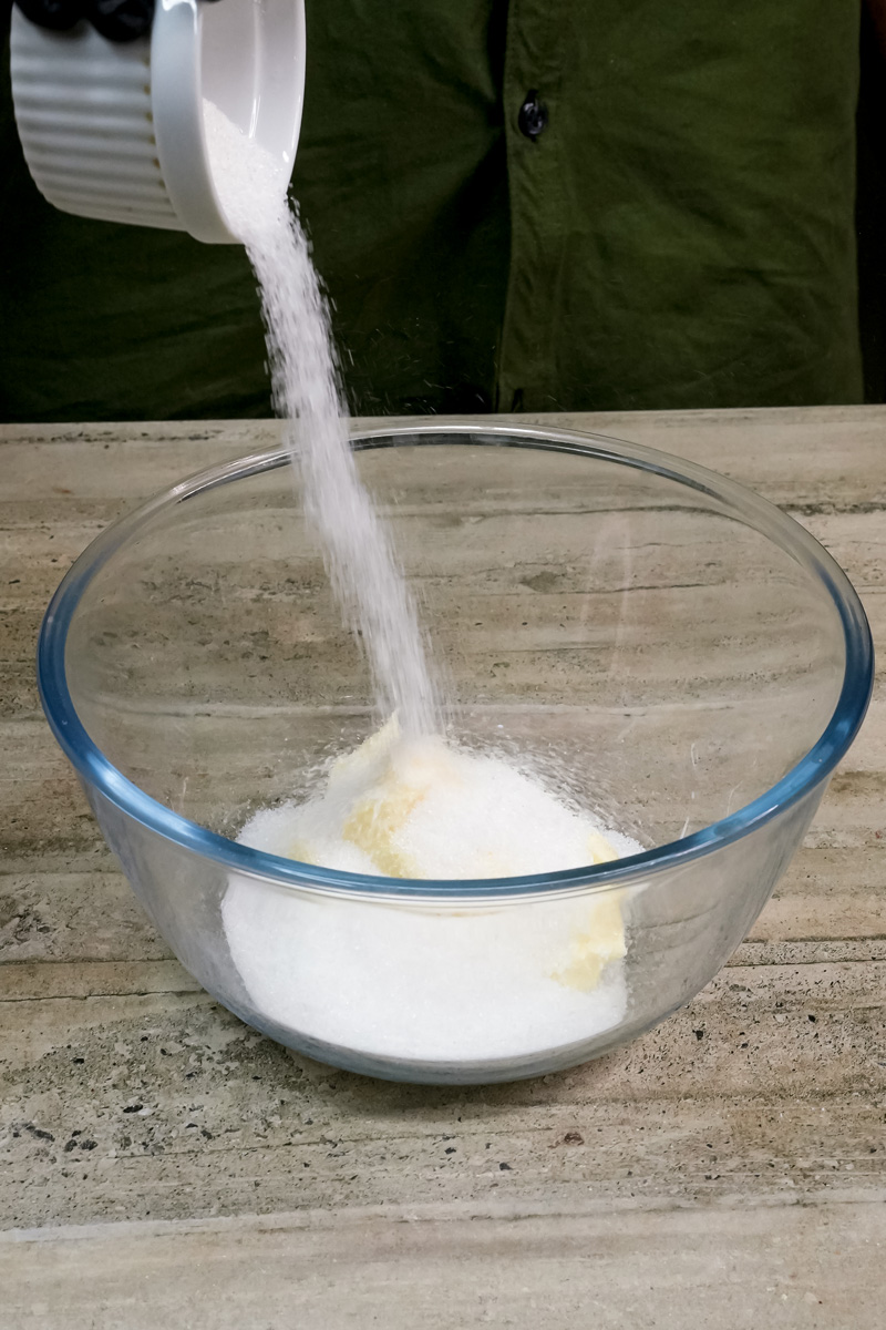 Adding flour to mixing bowl for milk cookies