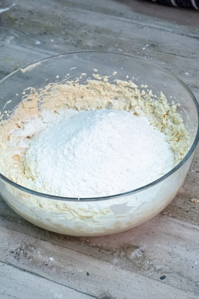 Adding flour to the gingerbread cookie dough