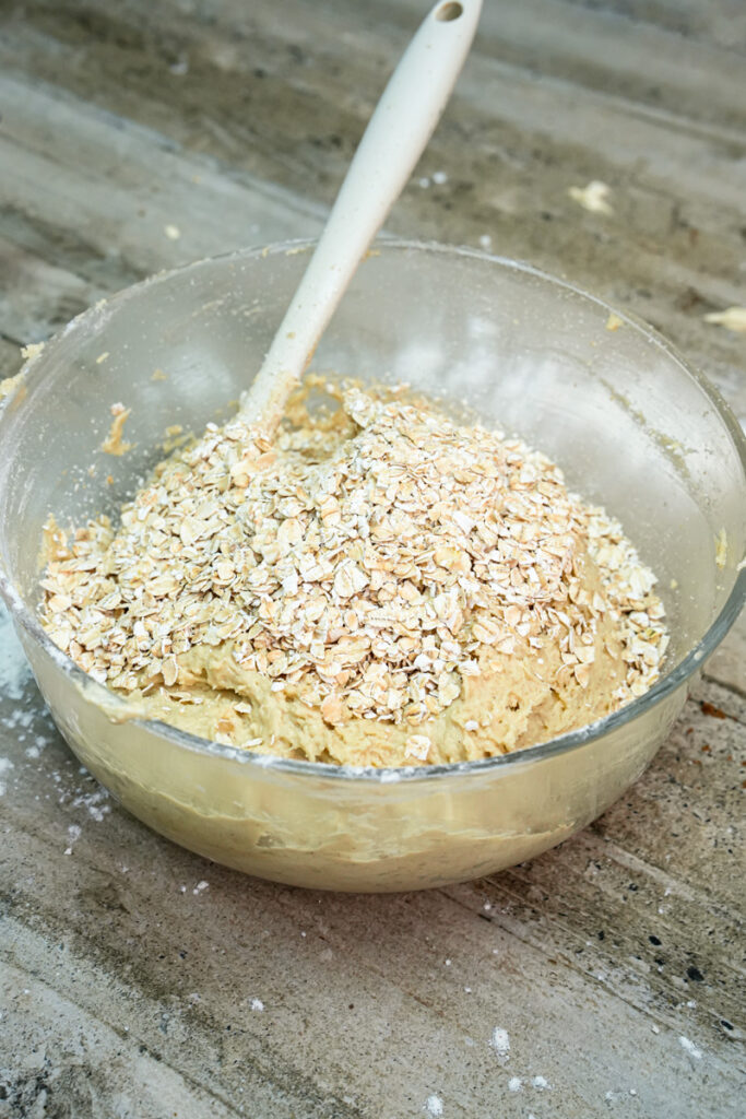 Adding rolled oats to cowboy cookie dough
