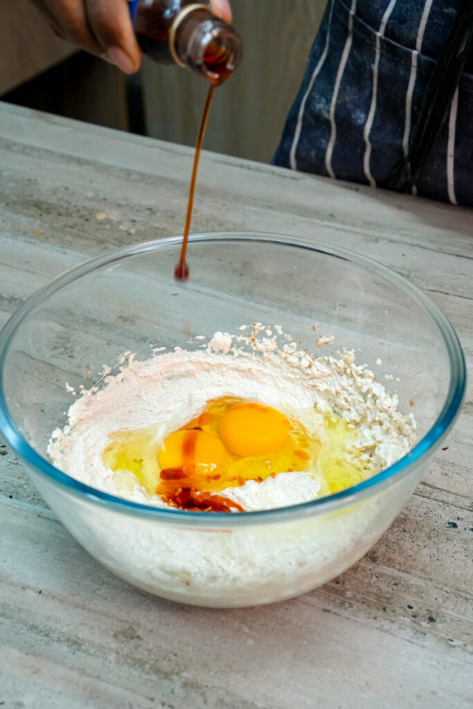 Adding vanilla extract to the cookie dough mixture