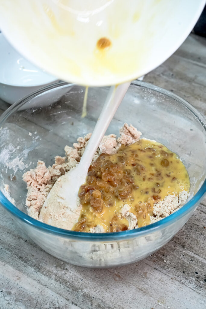 Adding wet ingredients to oatmeal cookie dough mixture