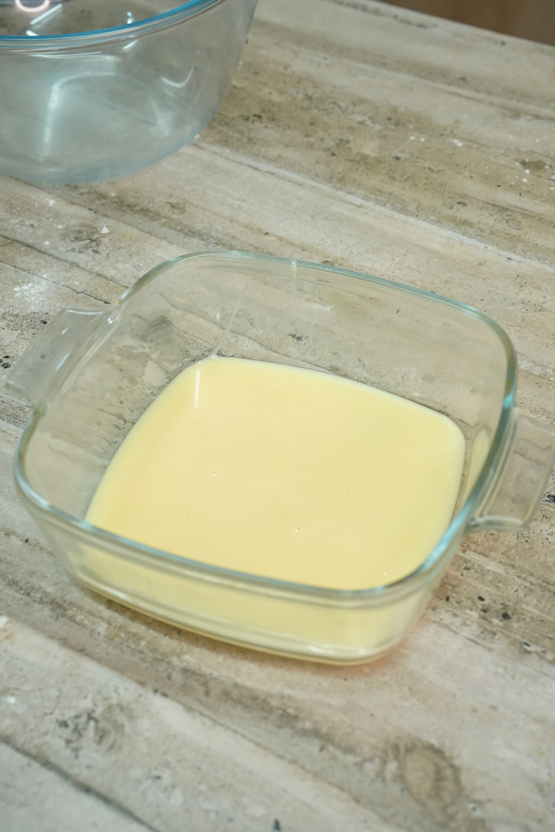 Alfajores cookie dough chilling in glass dish before rolling