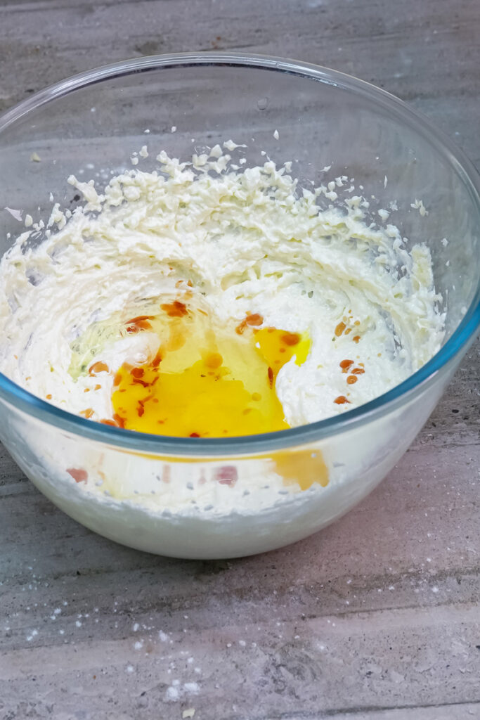 An egg yolk and vanilla extract added to the creamed butter and sugar mixture for oatmeal cookies