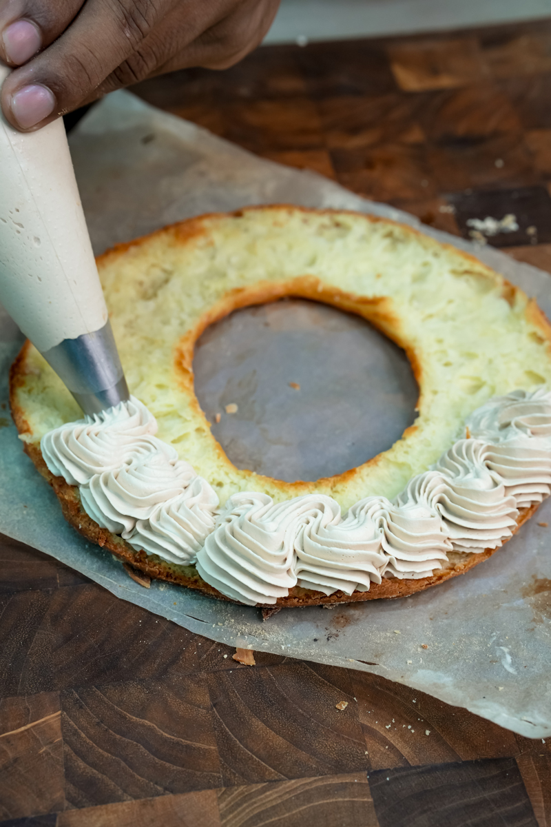 Baked Paris Brest choux pastry ring with piped cream filling