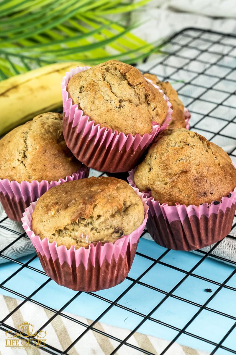 Baked banana muffins in pink and brown paper liners