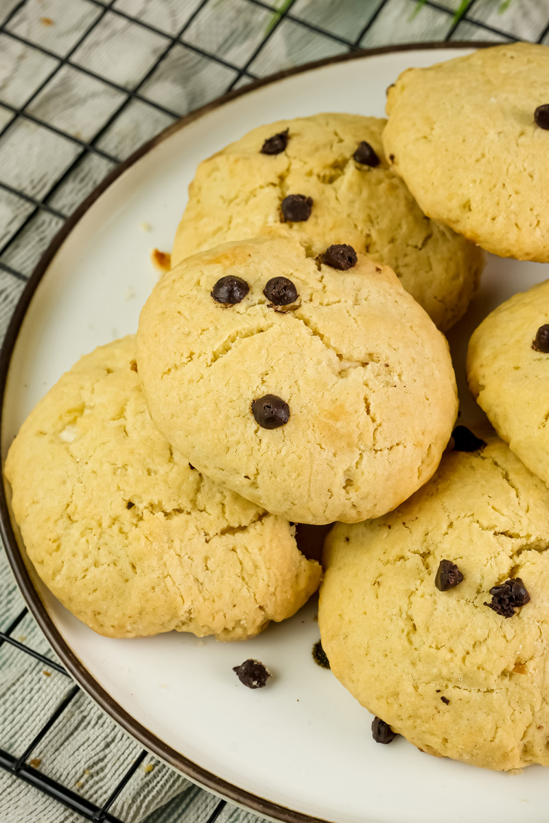Baked chocolate chip cheesecake cookies on white plate