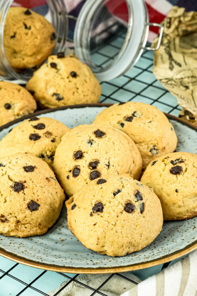 Baked chocolate chip cookies ready to be stored in a glass jar