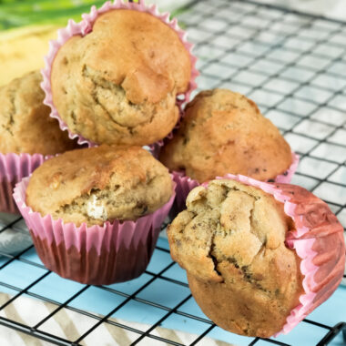 Banana muffins with a cooling rack and striped cloth