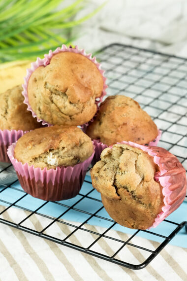 Banana muffins with a cooling rack and striped cloth