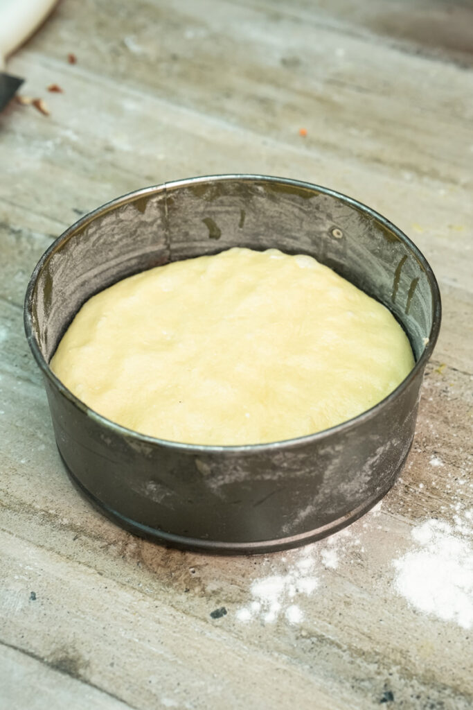 Bee sting cake batter in greased round cake pan ready for baking