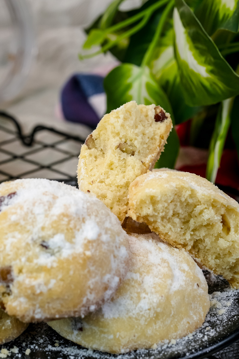 Broken Mexican wedding cookie showing tender crumb and walnut filling