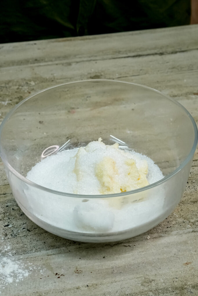Butter and powdered sugar mixed together in glass bowl