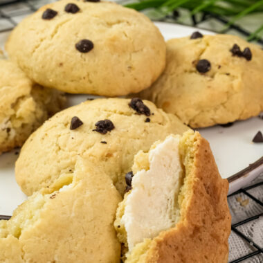 Cheesecake cookie cut in half showing cheese filling