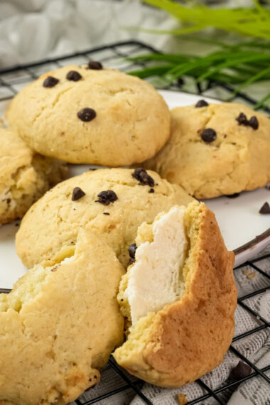 Cheesecake cookie cut in half showing cheese filling