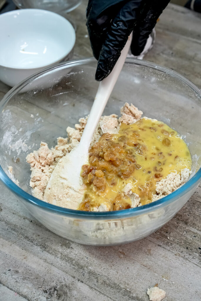 Combining wet and dry ingredients for oatmeal raisin cookie dough