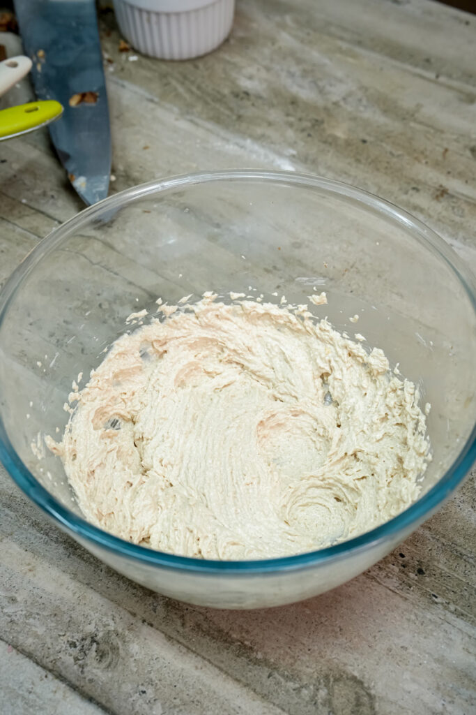 Creamed butter and sugar mixture in glass bowl