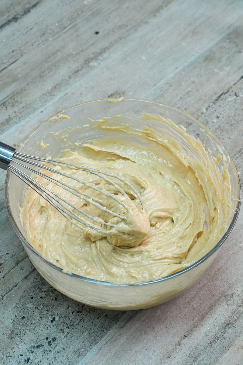 Creamed butter, peanut butter, and sugar whisked in a bowl
