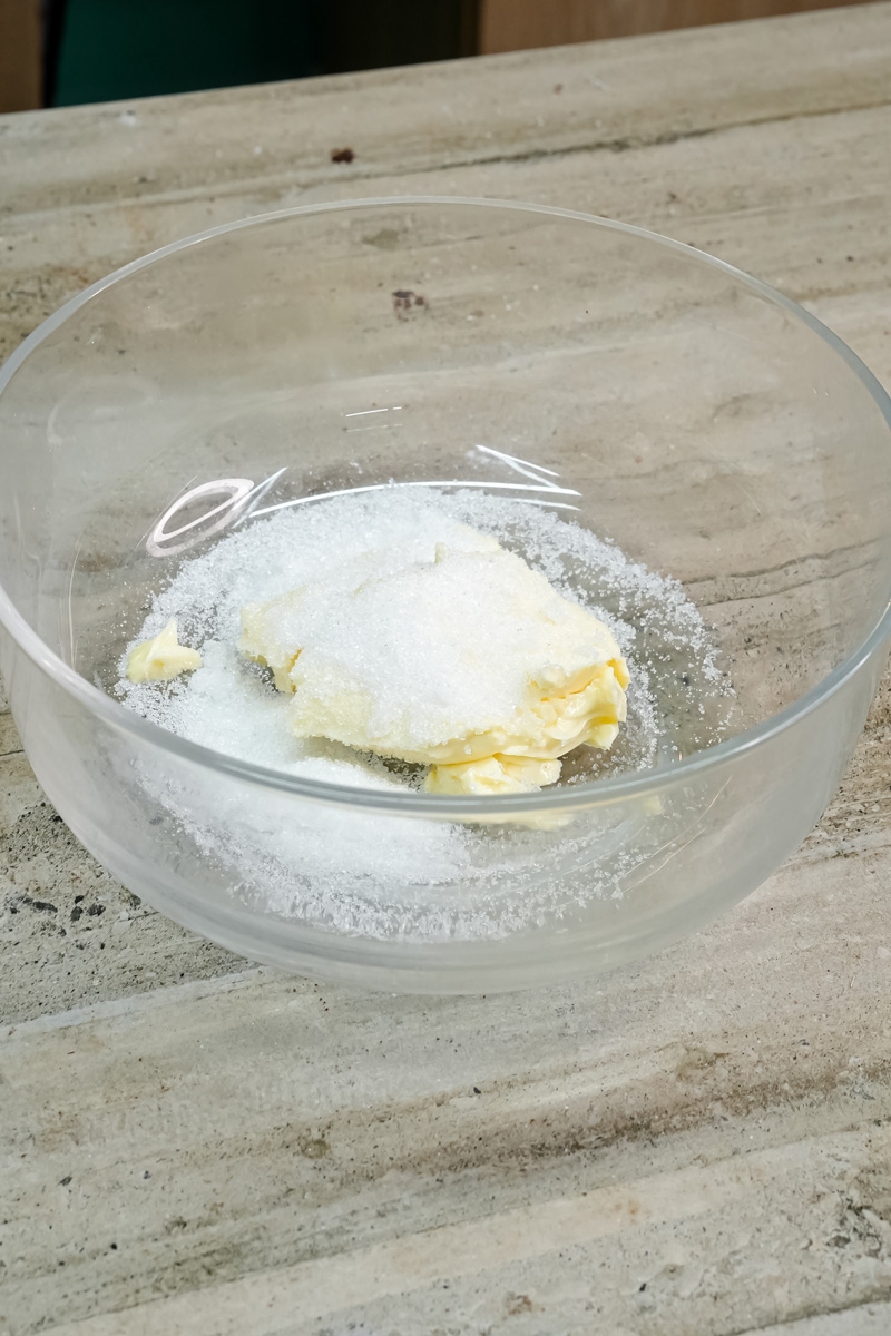 Creaming butter and sugar in glass mixing bowl with electric mixer