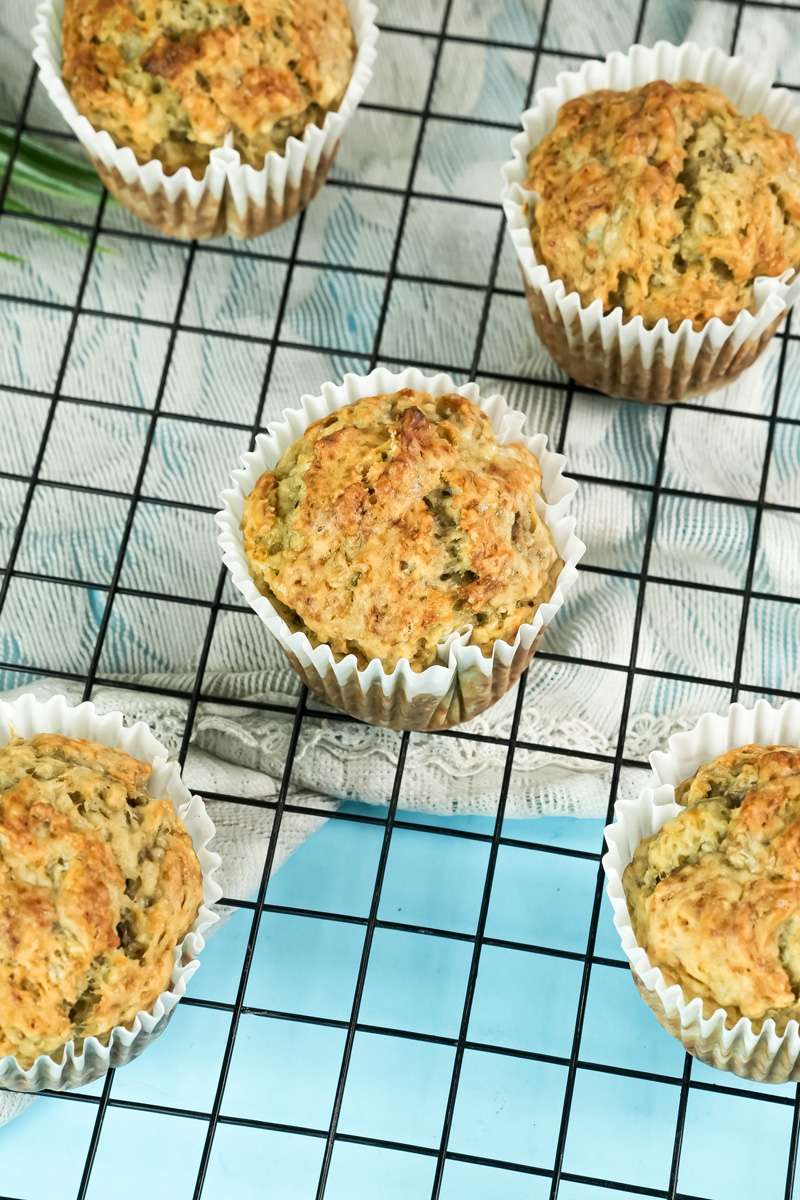 Delicious banana protein muffin with a golden top, cooling on a rack