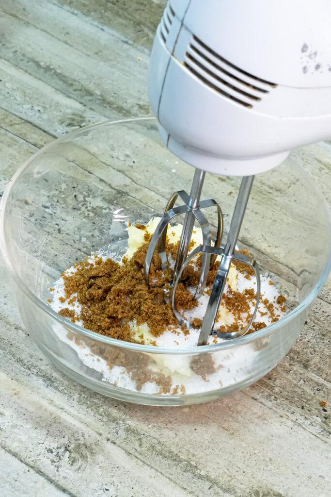 Electric mixer creaming butter and brown sugar for cookie dough