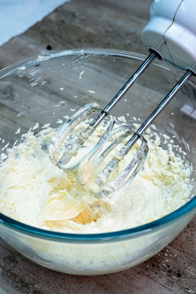 Electric mixer creaming butter and sugar together for churro cookies