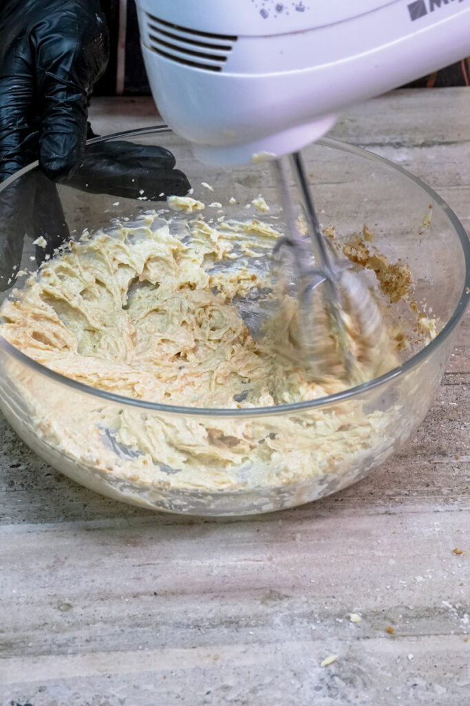 Electric mixer creaming together butter and sugars